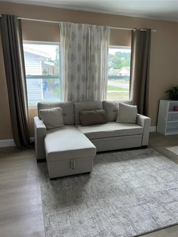 a living room with furniture and a large window