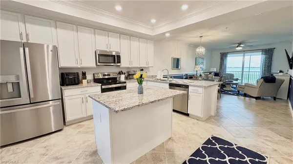 a kitchen with stainless steel appliances granite countertop a refrigerator stove microwave and sink