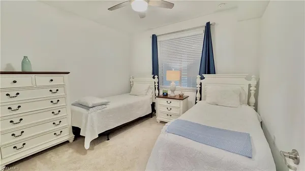 a spacious bedroom with a bed and a window