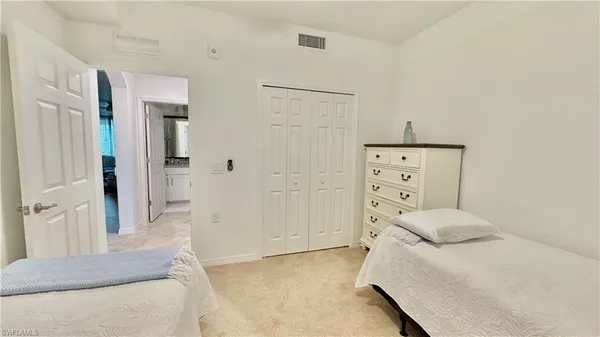 a bedroom with a bed and a cabinets