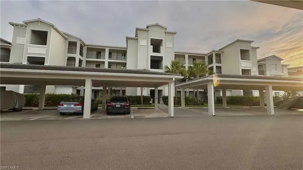 a view of building with car parked