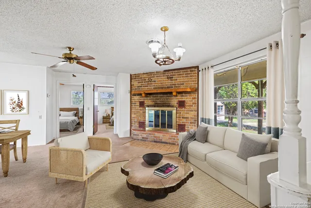 a view of a dining room with furniture a chandelier and wooden floor