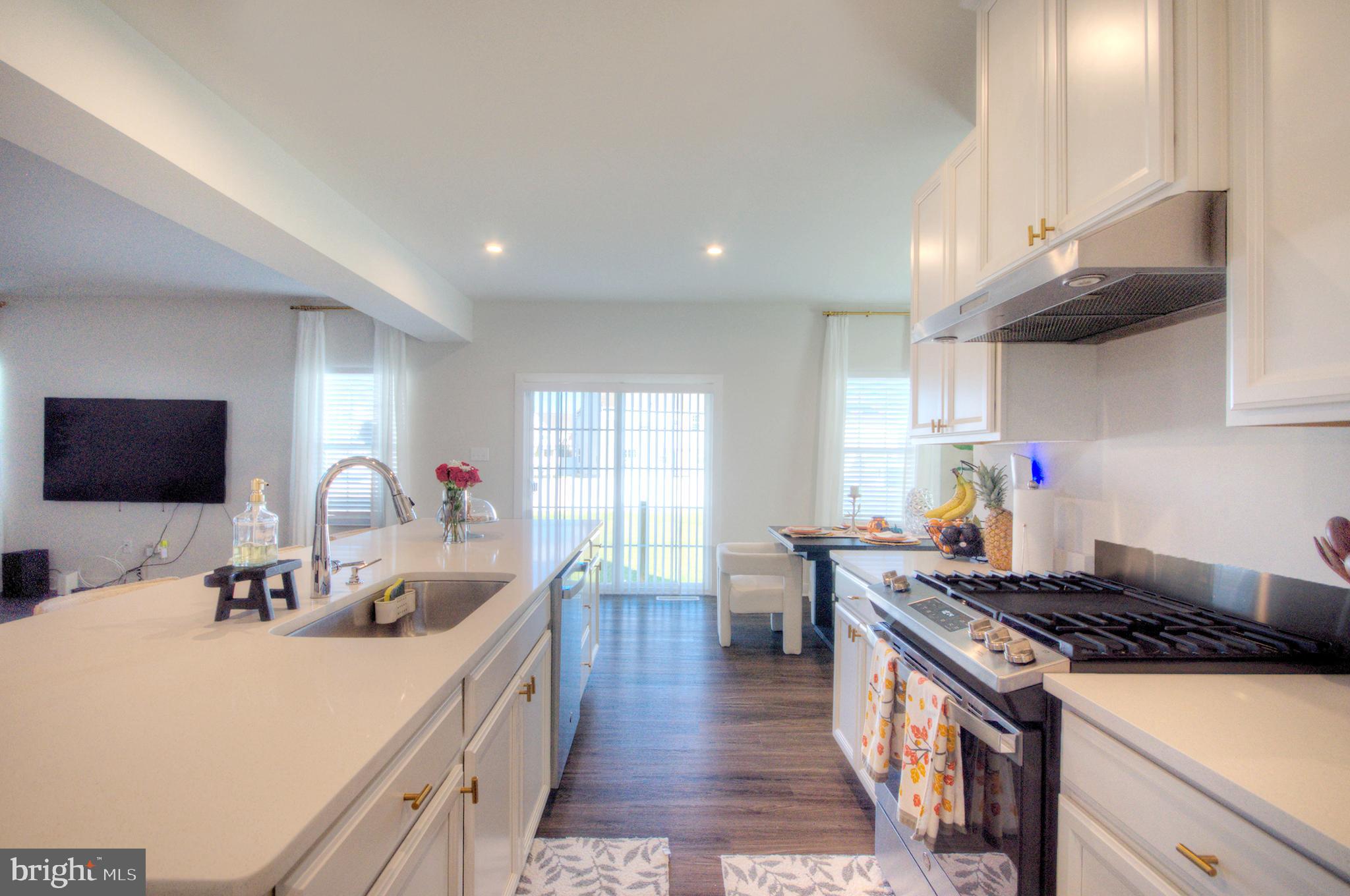 8 Eichmann Way Woodstown, NJ 08098 - Photo 11 of 47 a kitchen with kitchen island granite countertop a sink stove and cabinets