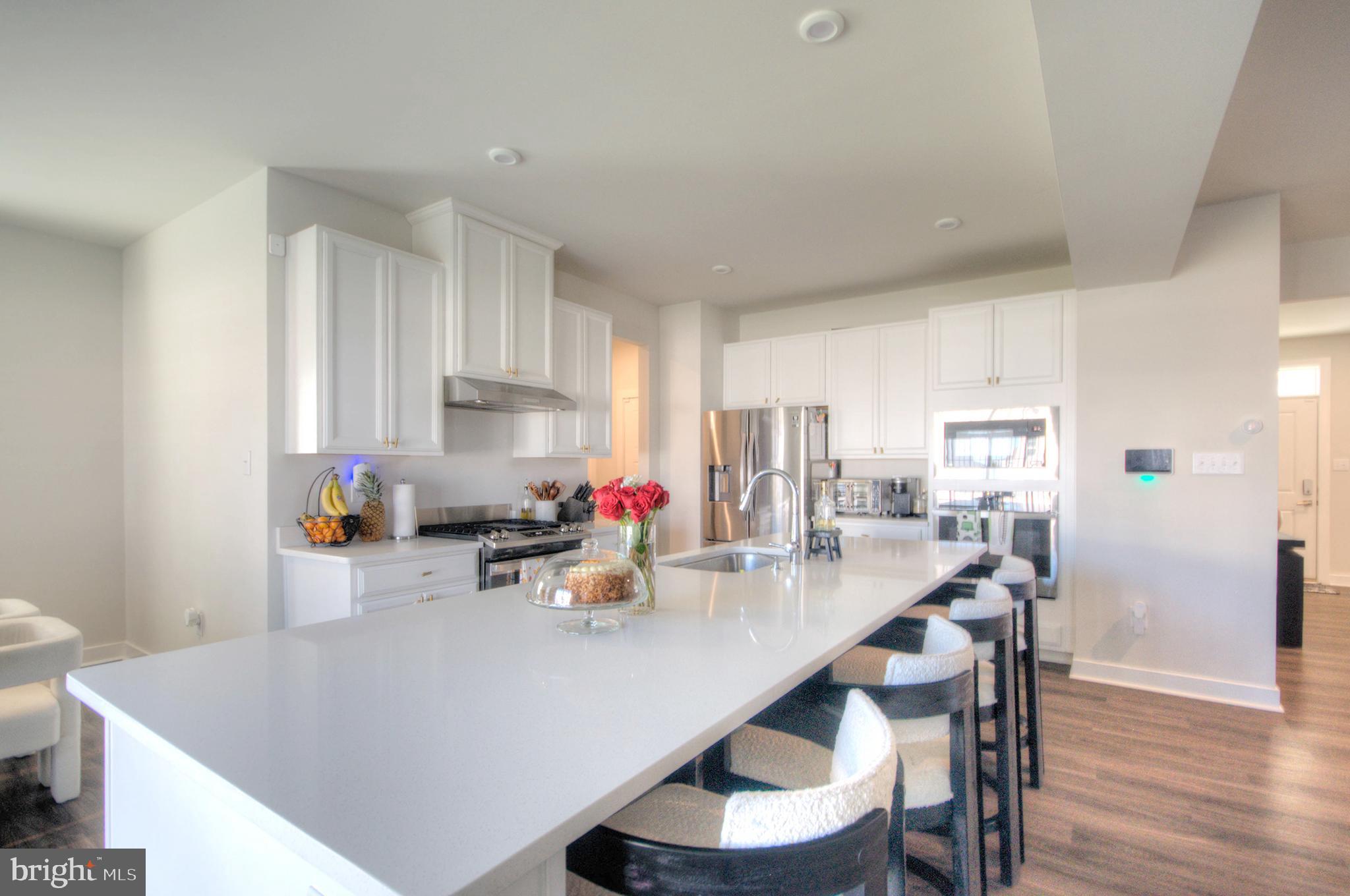 8 Eichmann Way Woodstown, NJ 08098 - Photo 3 of 47 a kitchen with a dining table chairs and refrigerator