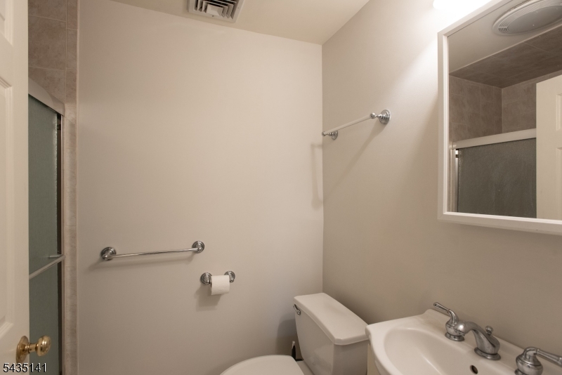 14 Locust Street Madison, NJ 07940 - Photo 26 of 33 a bathroom with a toilet and sink