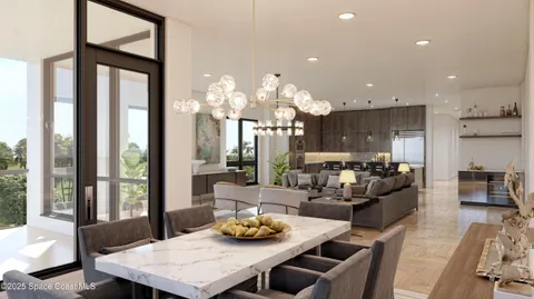 a living room with furniture large windows and wooden floor