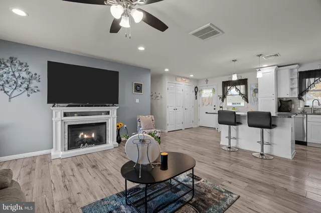 a living room with furniture a fireplace and a flat screen tv
