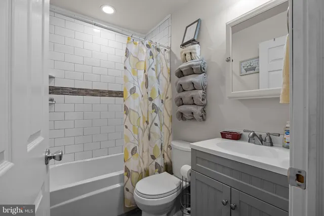 a living room with furniture and a ceiling fan