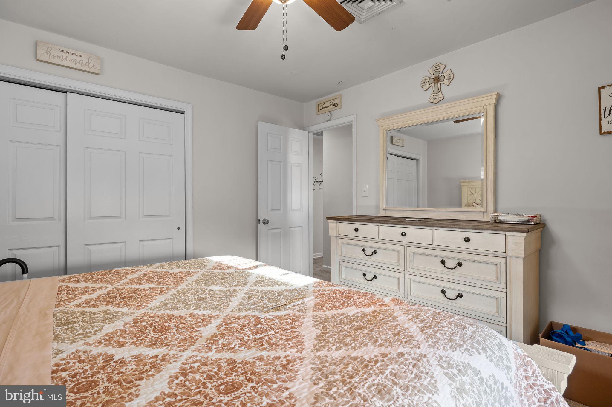 179 Crabtree Drive Levittown, PA 19055 - Photo 20 of 25 a bedroom with a bed and a mirror on dresser