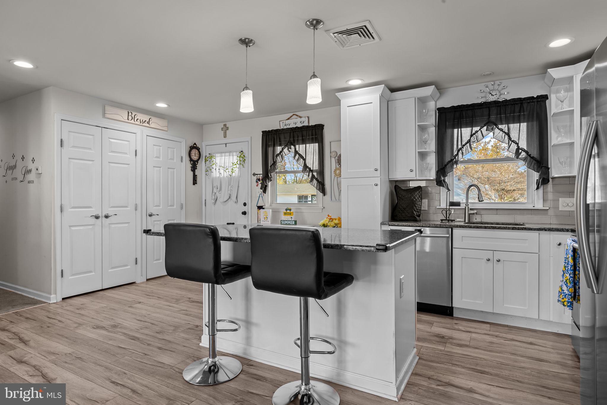 179 Crabtree Drive Levittown, PA 19055 - Photo 6 of 25 a kitchen with stainless steel appliances kitchen island granite countertop a stove a sink and a refrigerator