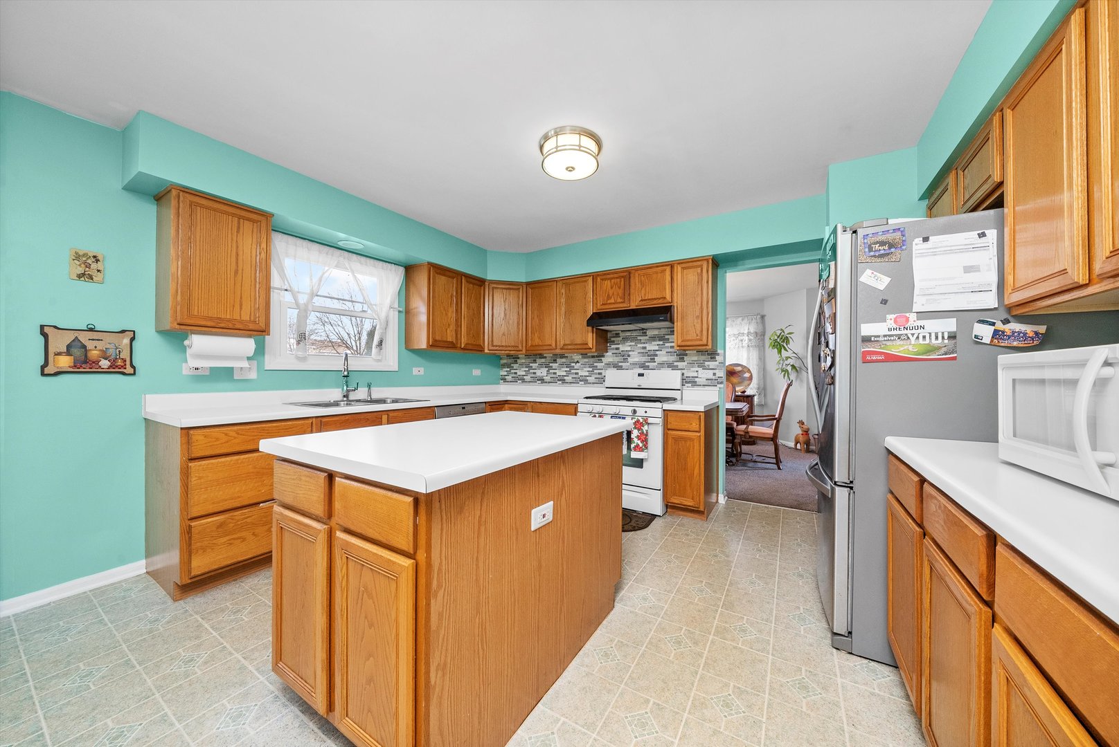 258 Silverado Street Bolingbrook, IL 60490 - Photo 12 of 31 a kitchen with a stove a refrigerator and a sink