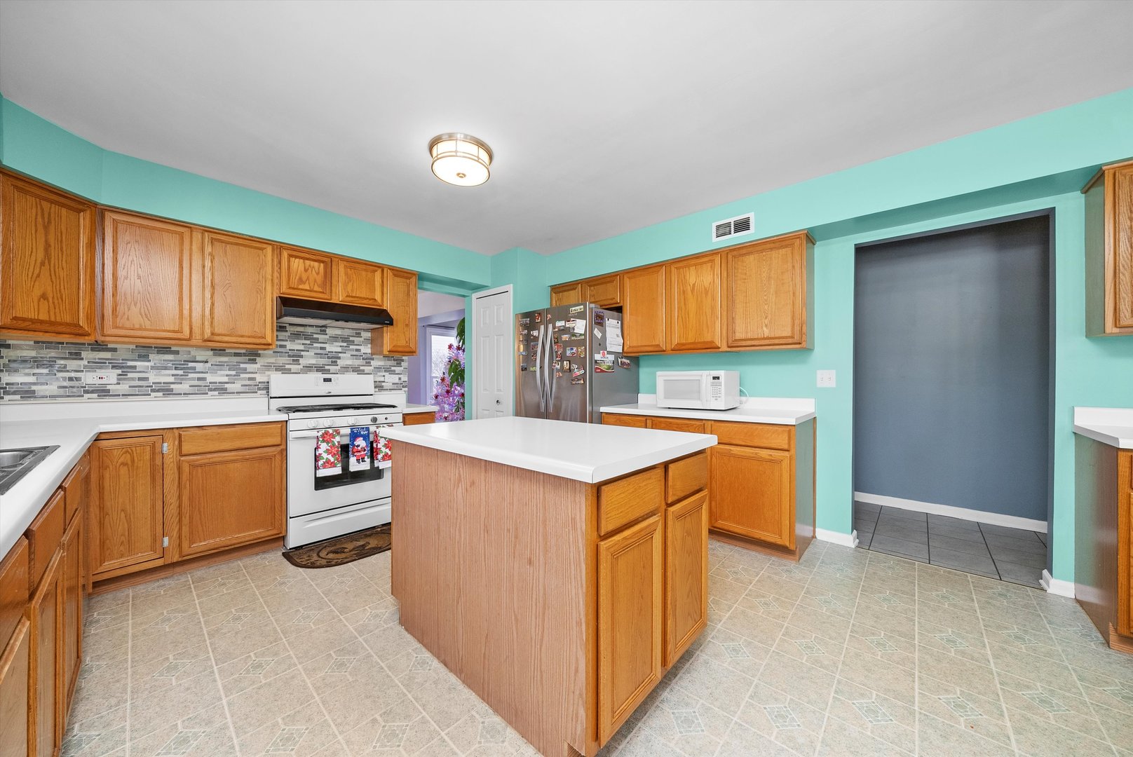 258 Silverado Street Bolingbrook, IL 60490 - Photo 13 of 31 a kitchen with stainless steel appliances granite countertop a stove and a sink