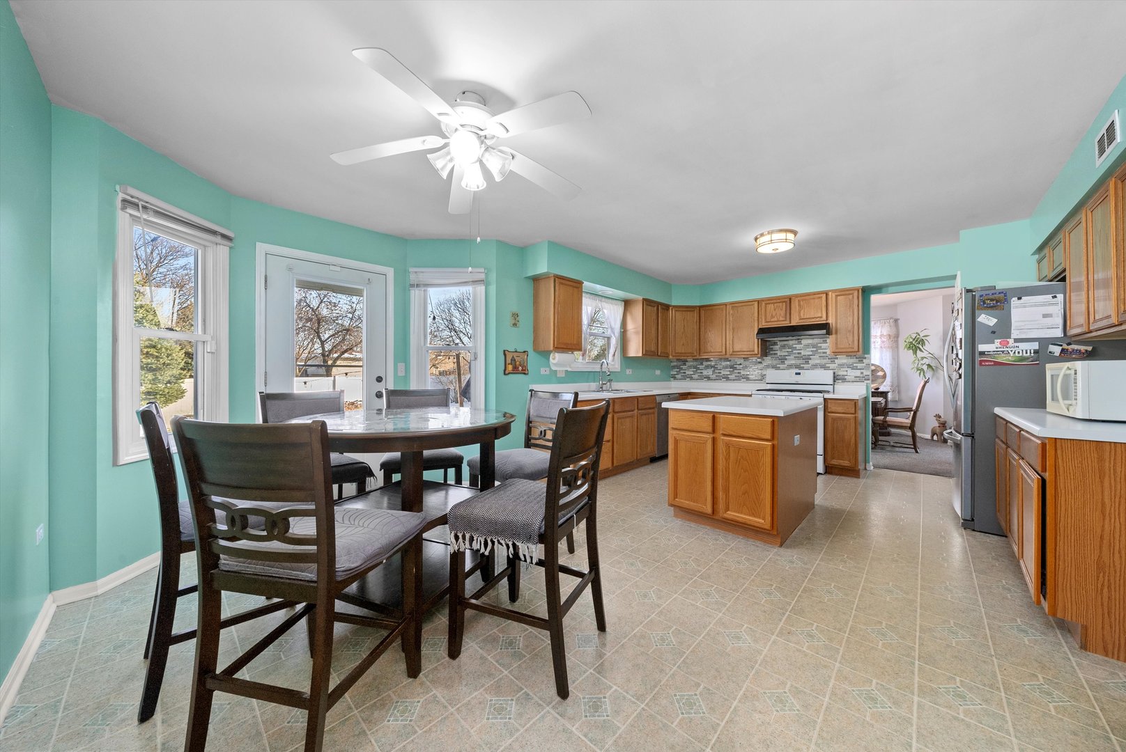 258 Silverado Street Bolingbrook, IL 60490 - Photo 15 of 31 a view of a dining room with furniture and a kitchen