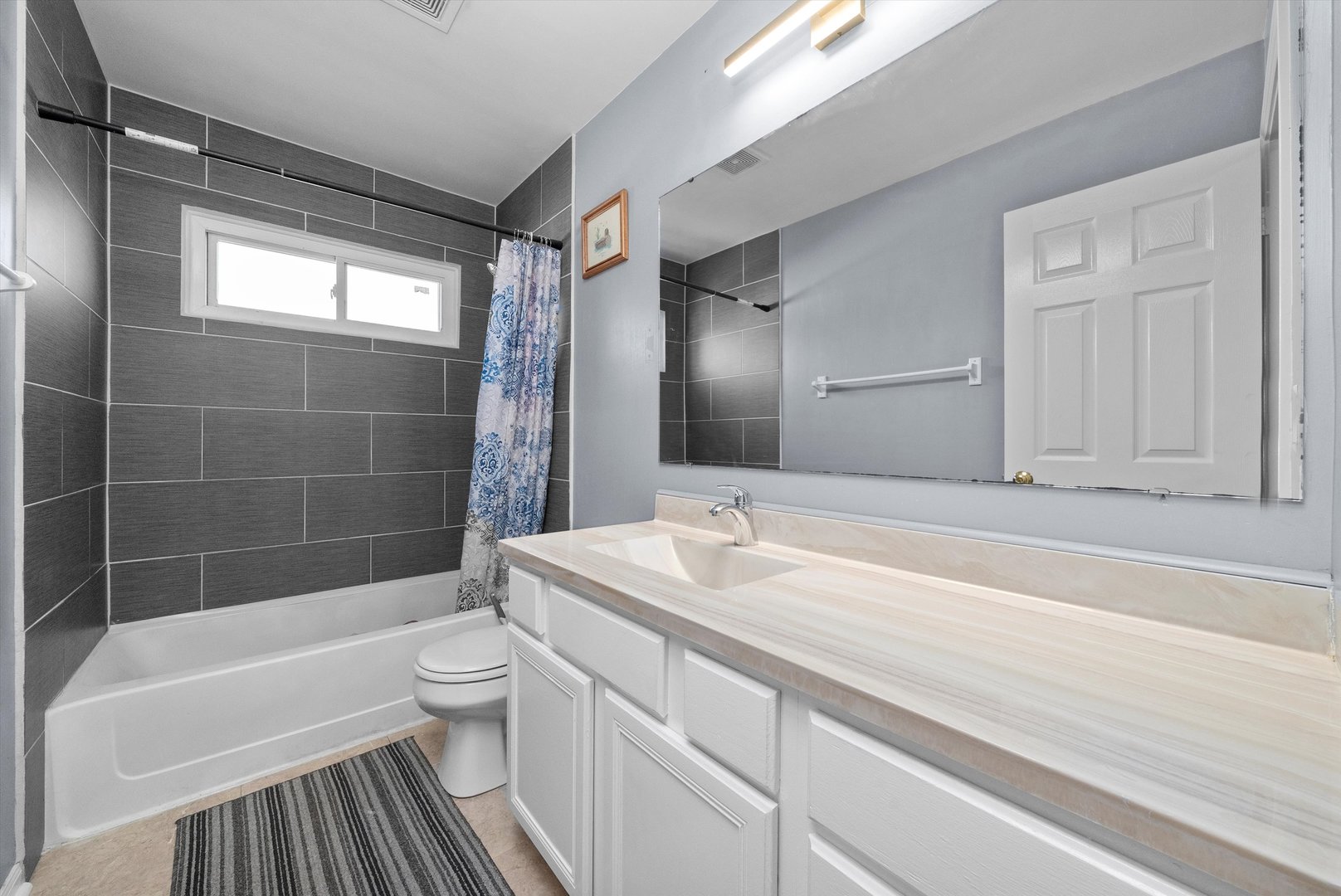 258 Silverado Street Bolingbrook, IL 60490 - Photo 21 of 31 a bathroom with a sink a toilet a mirror a bathtub and shower