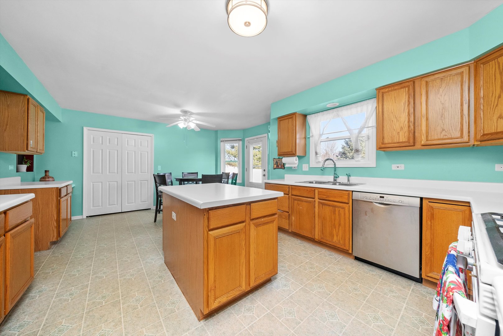 258 Silverado Street Bolingbrook, IL 60490 - Photo 10 of 31 a kitchen that has a sink and a stove in it