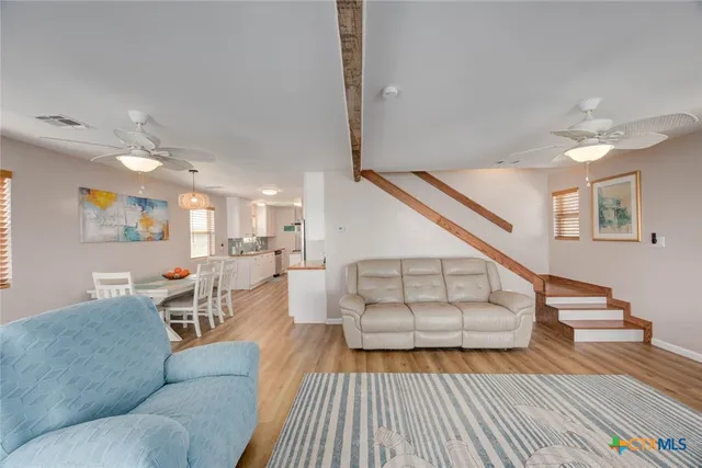 a view of a dining room with furniture wooden floor and a chandelier