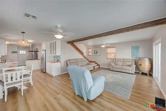 a spacious bedroom with a bed a couch and a window