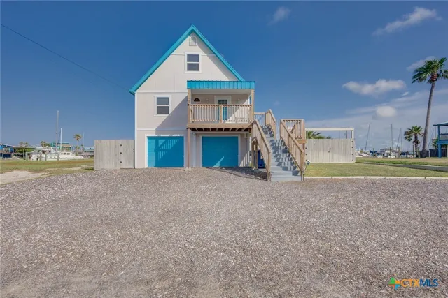 a view of a house with a yard and garage