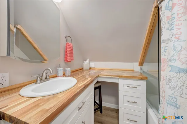 a bathroom with a glass shower door