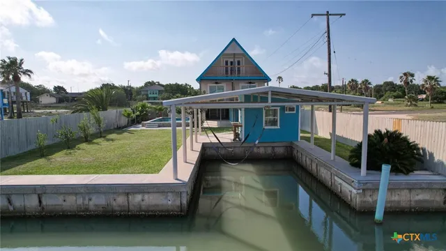 a view of house with swimming pool and outdoor seating