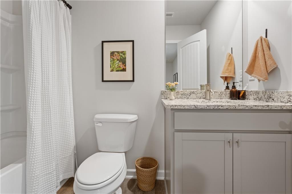 122 Meadowview Drive, Unit 11 Temple, GA 30179 - Photo 14 of 25 a bathroom with a toilet sink and mirror