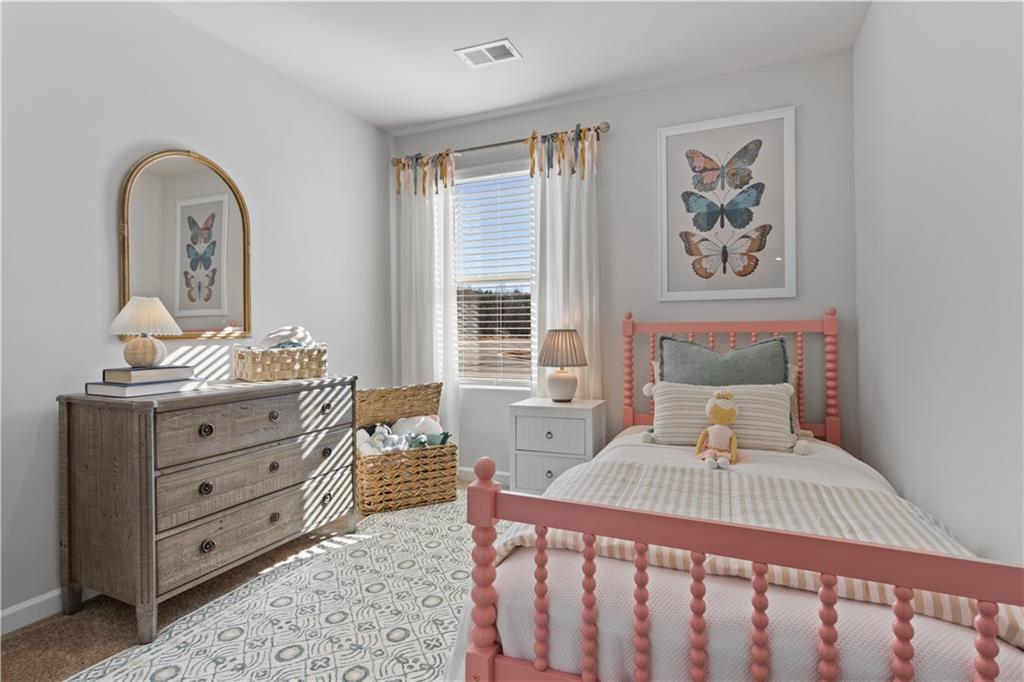 122 Meadowview Drive, Unit 11 Temple, GA 30179 - Photo 16 of 25 a bedroom with a bed and wooden floor