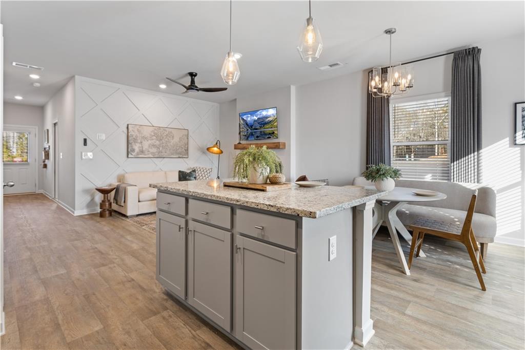122 Meadowview Drive, Unit 11 Temple, GA 30179 - Photo 10 of 25 a kitchen with kitchen island granite countertop a sink and a refrigerator