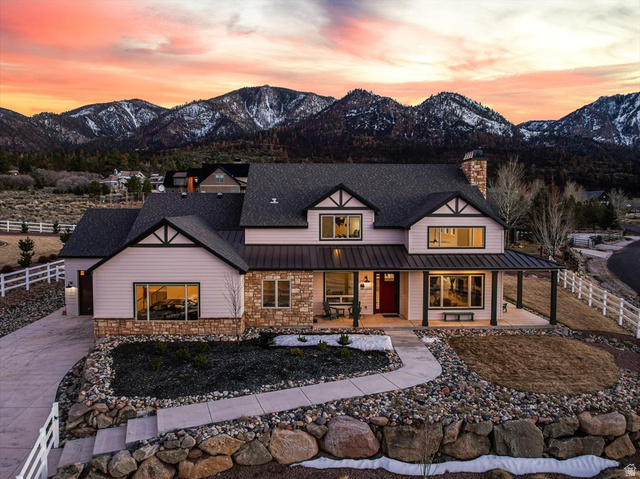 1210 East Bristle Cone Road Pine Valley, UT 84781 - Photo 1 of 54 View of front of home with a mountain view, covered porch, a chimney, stone siding, and a standing seam roof