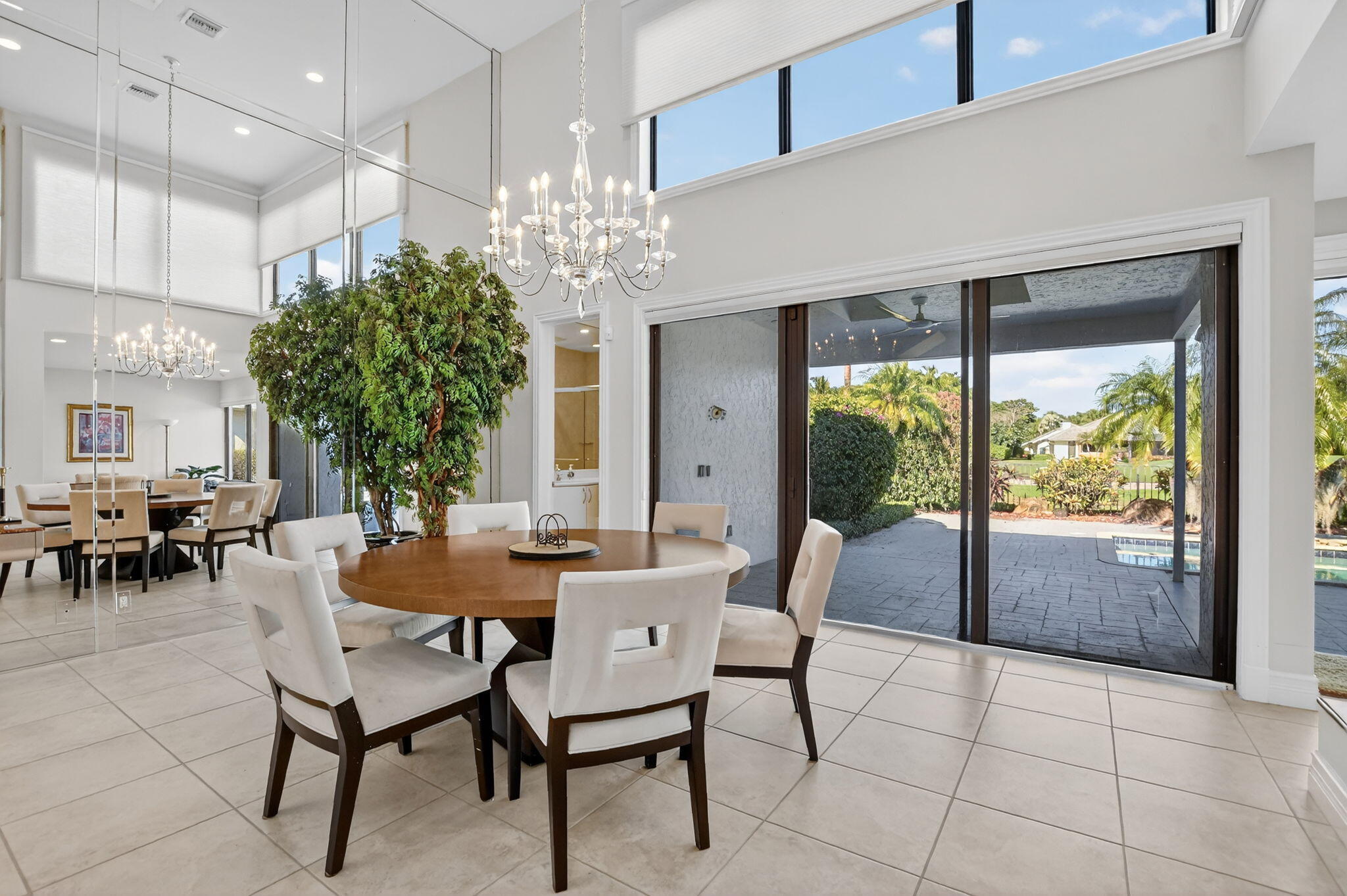 7567 Rexford Road Boca Raton, FL 33434 - Photo 2 of 95 a dining room with furniture a chandelier and window
