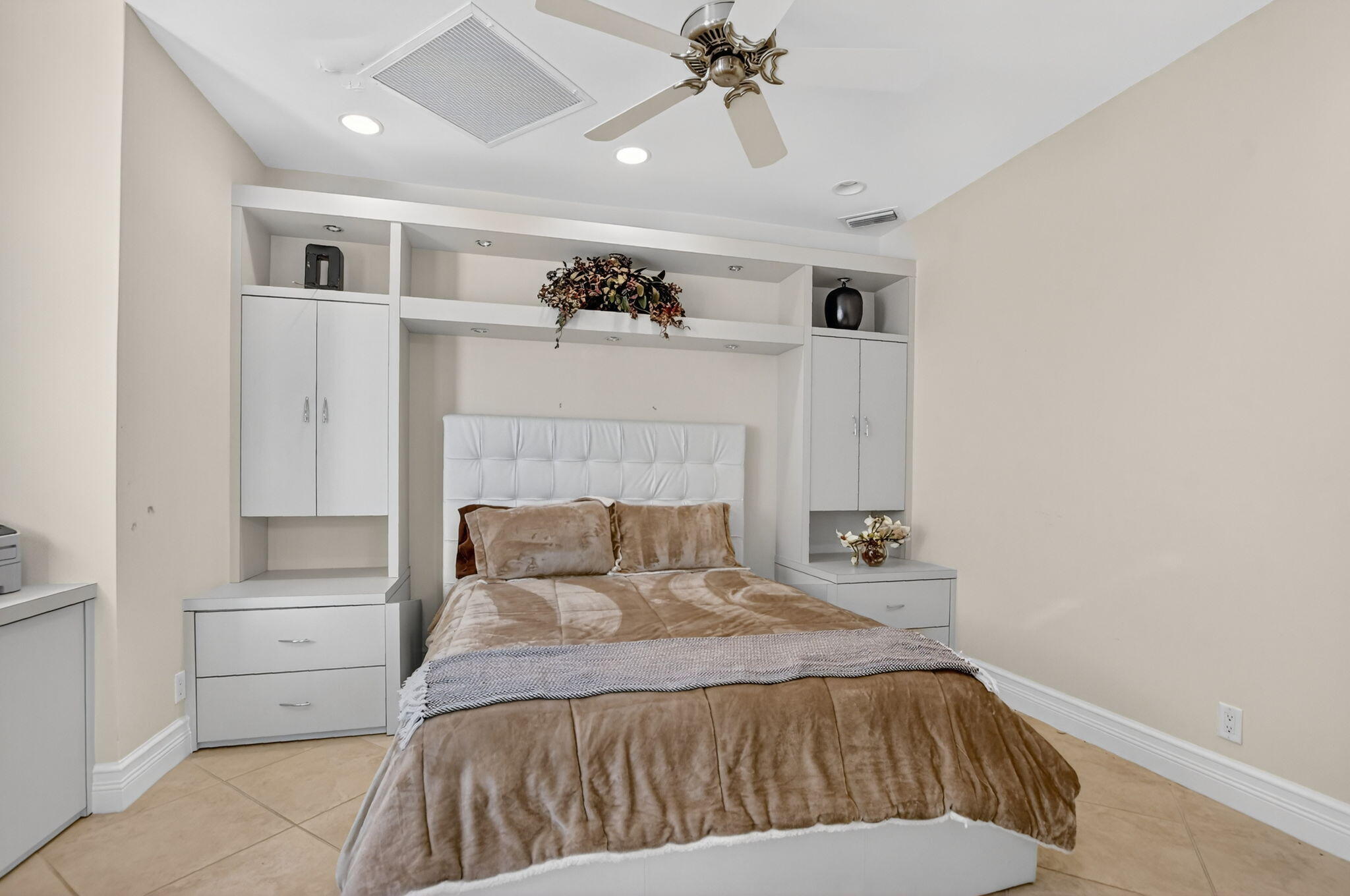 7567 Rexford Road Boca Raton, FL 33434 - Photo 25 of 95 a bedroom with a bed and a chandelier
