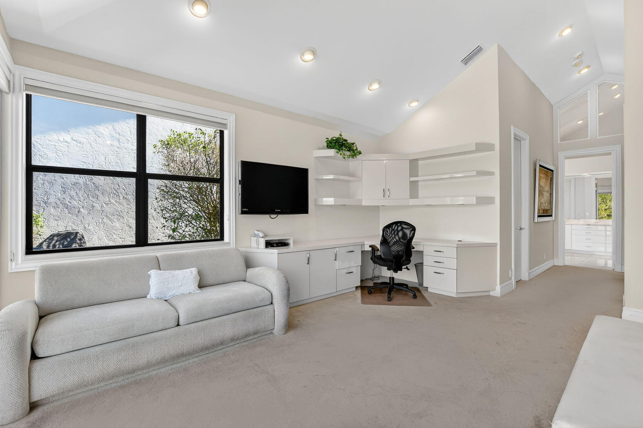 7567 Rexford Road Boca Raton, FL 33434 - Photo 30 of 95 a living room with furniture a flat screen tv and a large window