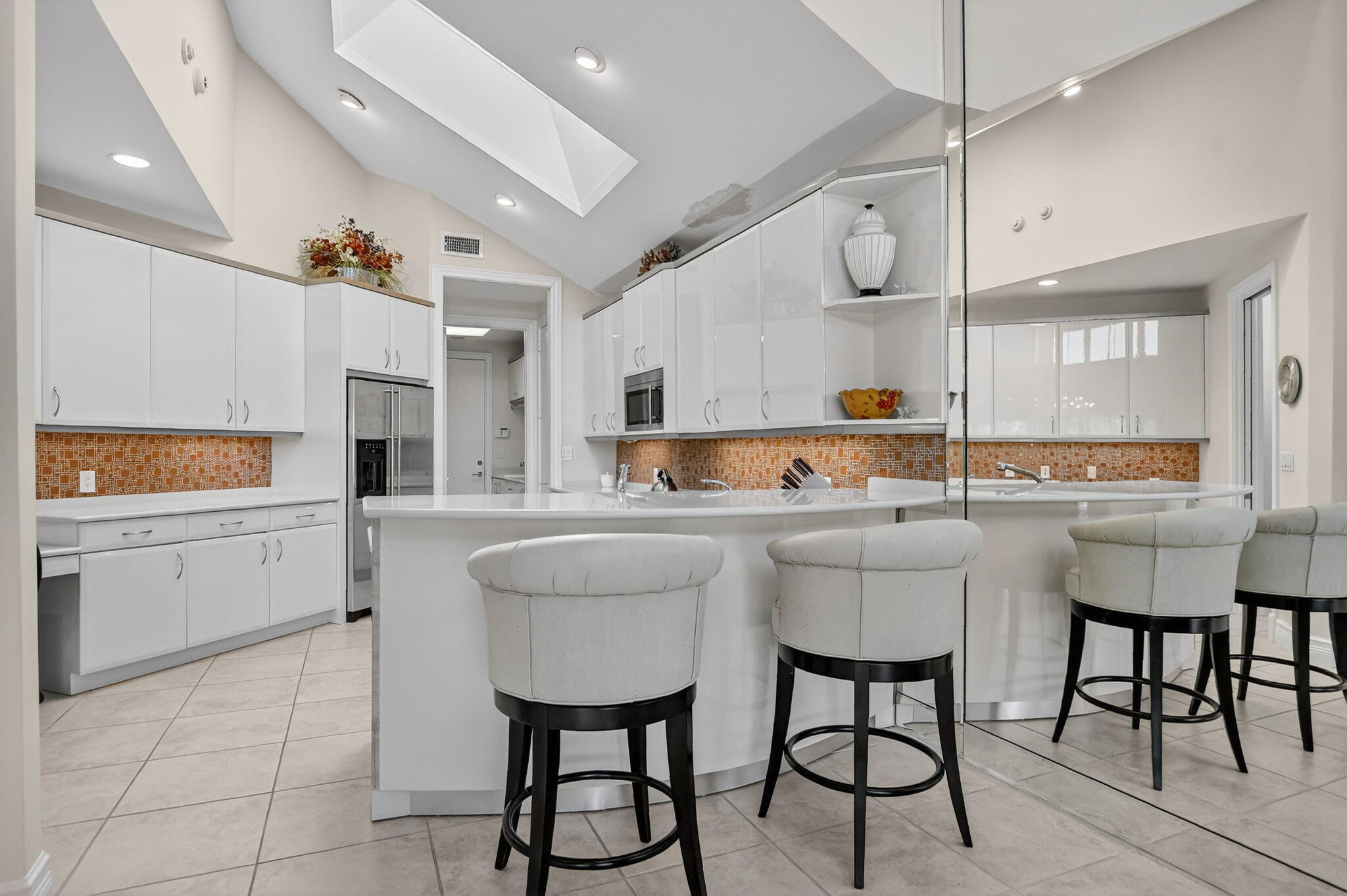 7567 Rexford Road Boca Raton, FL 33434 - Photo 3 of 95 a kitchen with stainless steel appliances kitchen island granite countertop a table chairs sink and cabinets