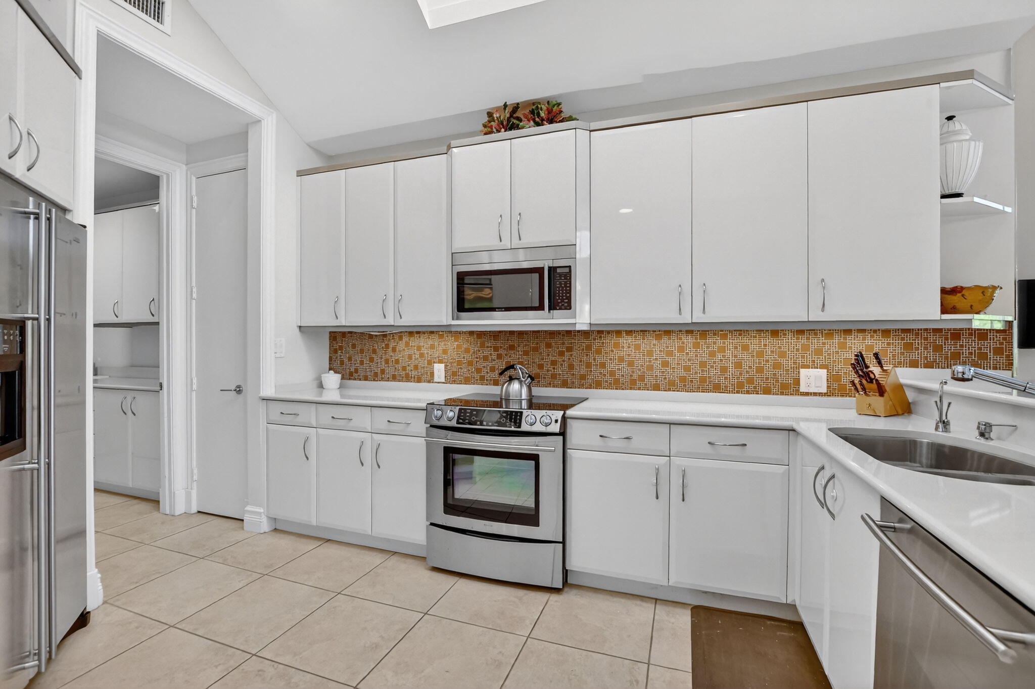 7567 Rexford Road Boca Raton, FL 33434 - Photo 4 of 95 a kitchen with cabinets appliances and a sink