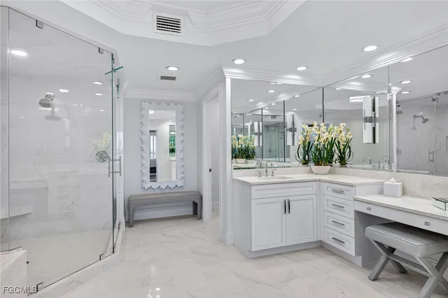 a bathroom with a double vanity sink toilet and shower