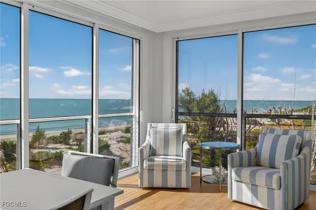 a living room with furniture a rug and glass door