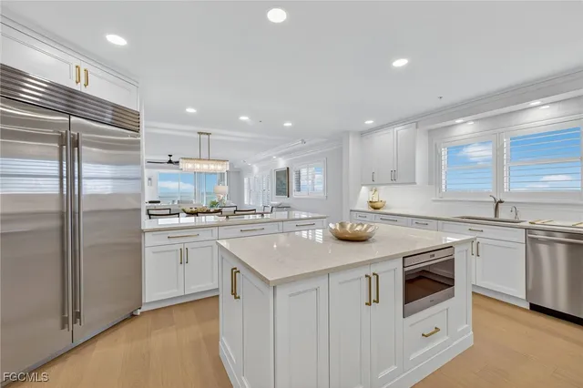 a kitchen with stainless steel appliances granite countertop a sink and cabinets