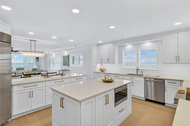 a kitchen with a sink a stove and cabinets