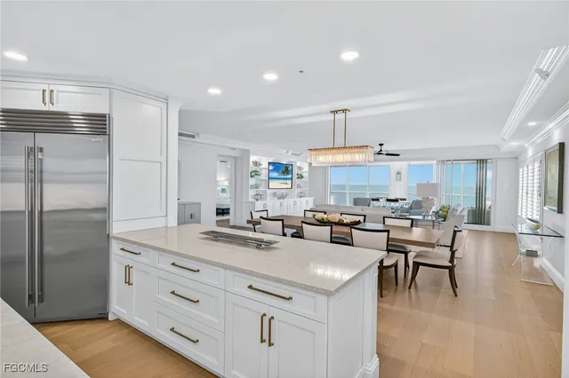 a kitchen with a refrigerator and a stove top oven