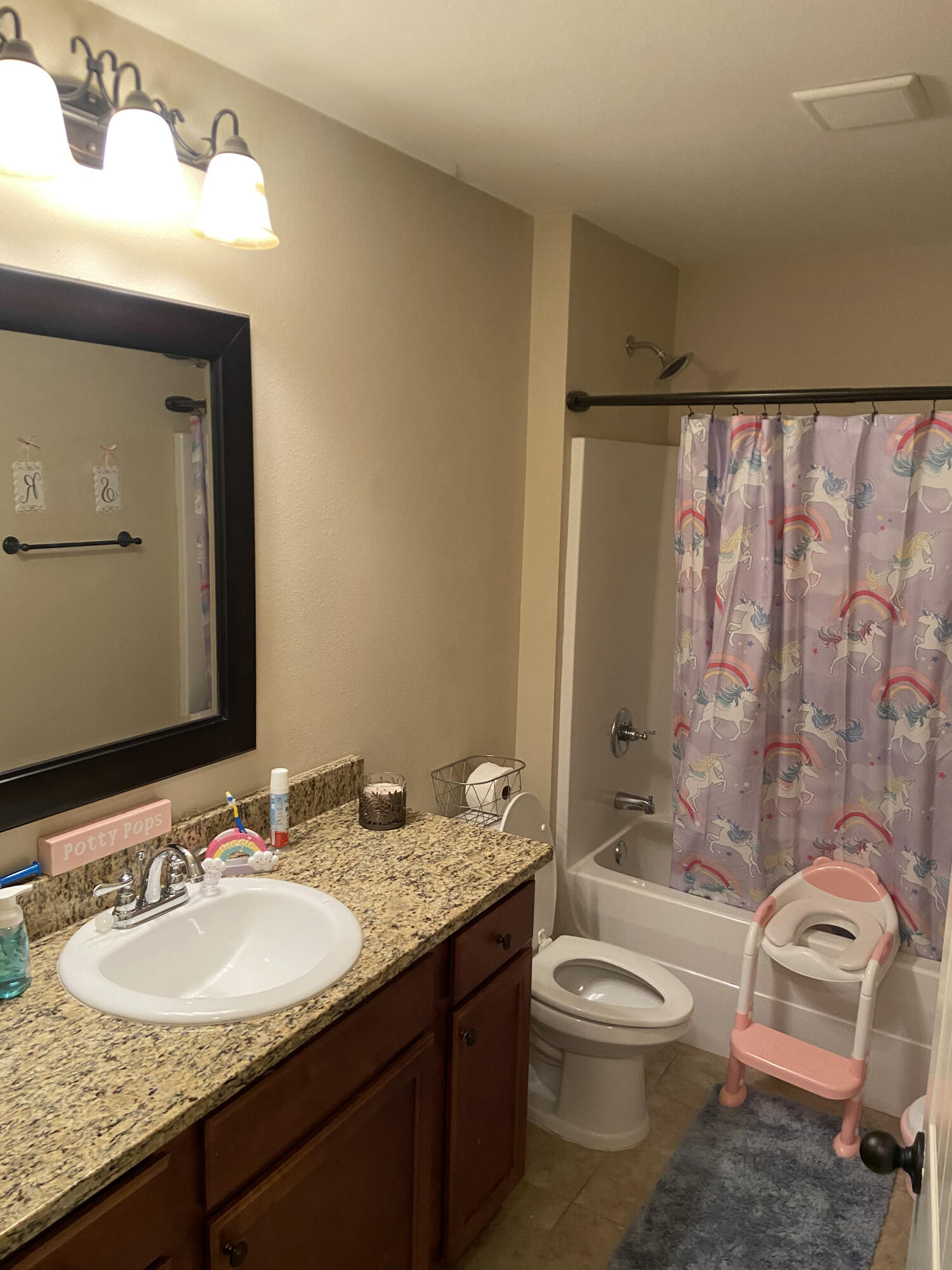 516 Grand Ridge Drive Crestview, FL 32539 - Photo 19 of 30 a bathroom with a granite countertop sink toilet a mirror and bathtub