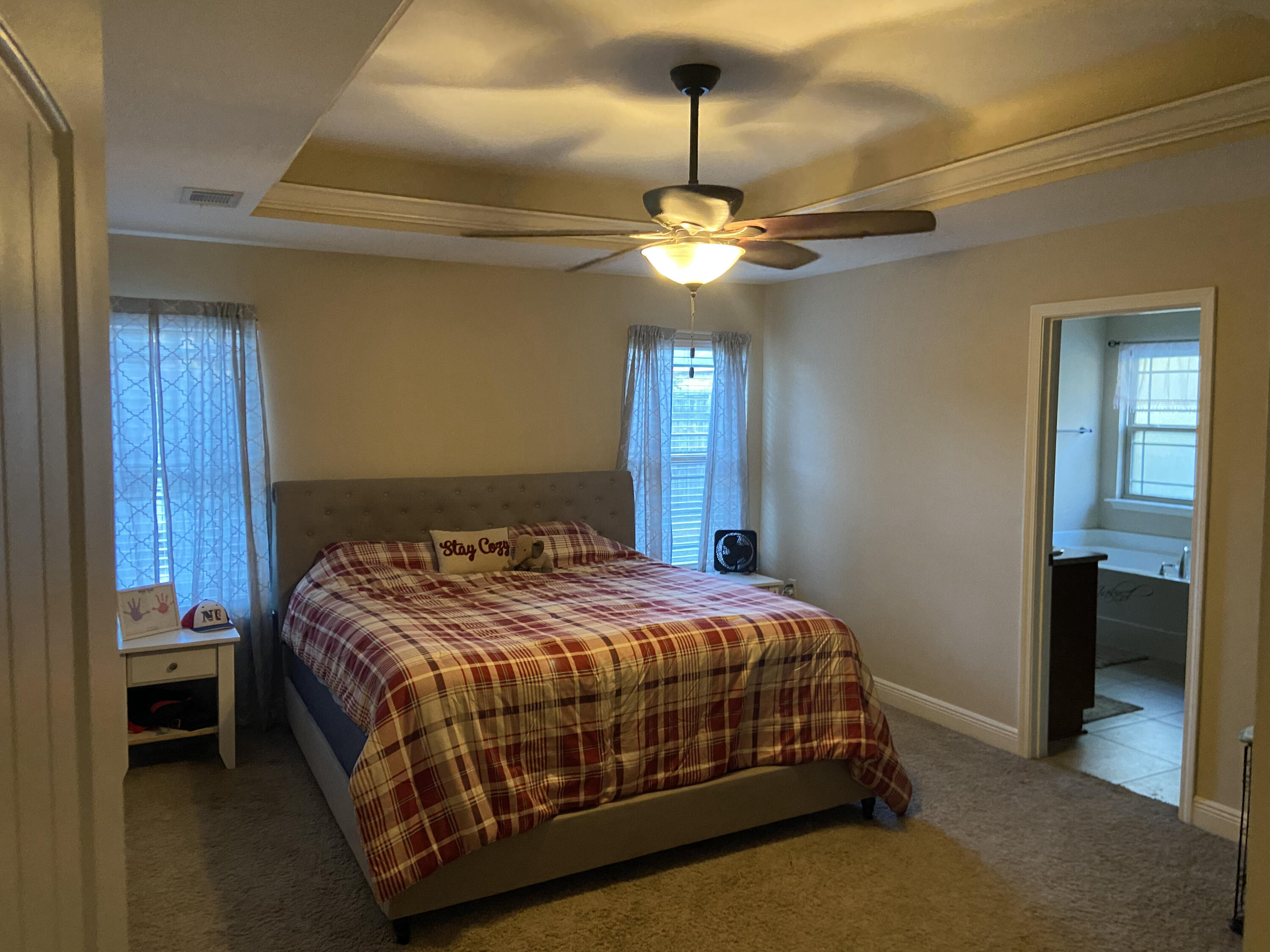 516 Grand Ridge Drive Crestview, FL 32539 - Photo 21 of 30 a bedroom with a bed and a chandelier