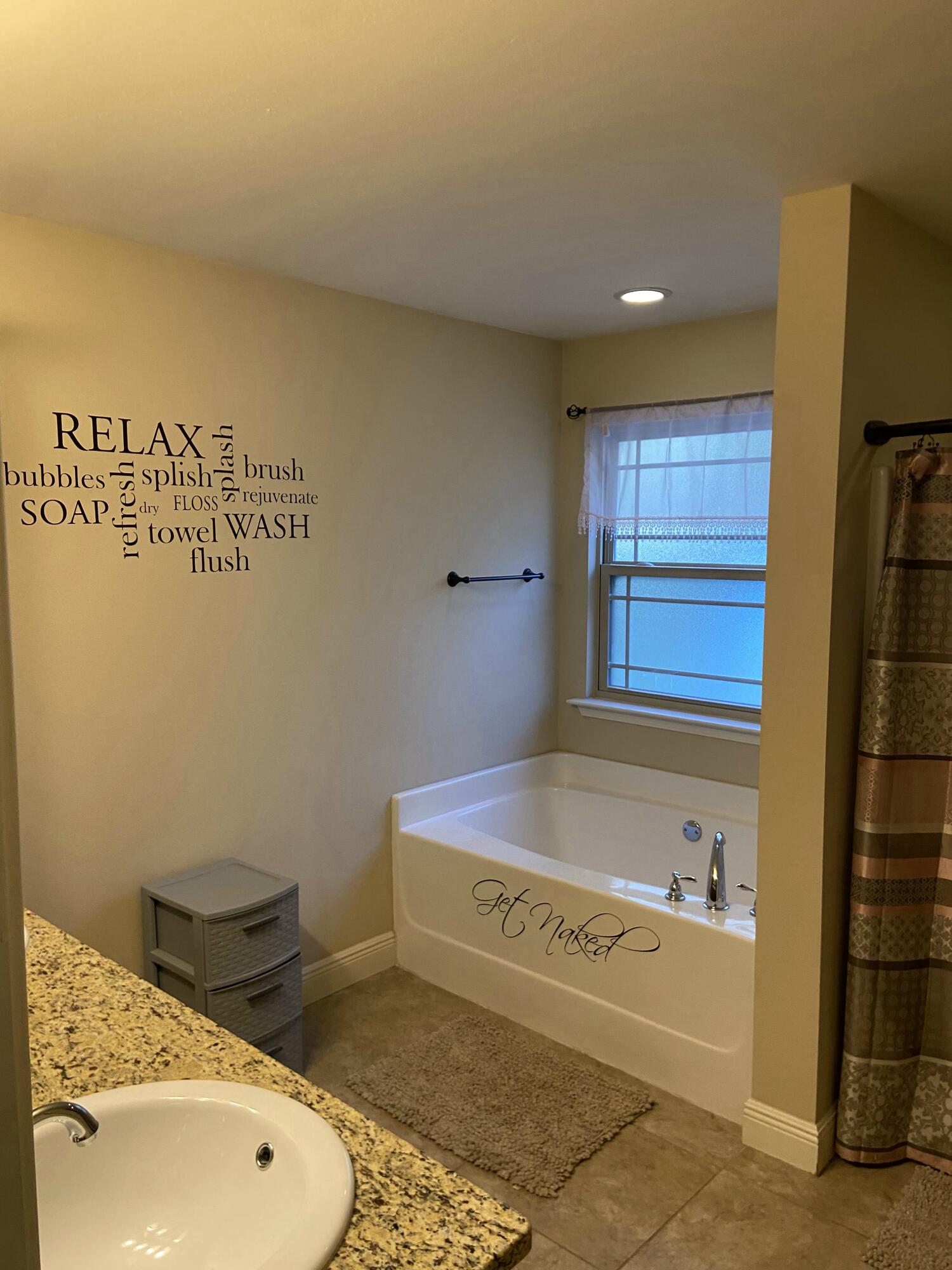 516 Grand Ridge Drive Crestview, FL 32539 - Photo 22 of 30 a bathroom with a tub and sink