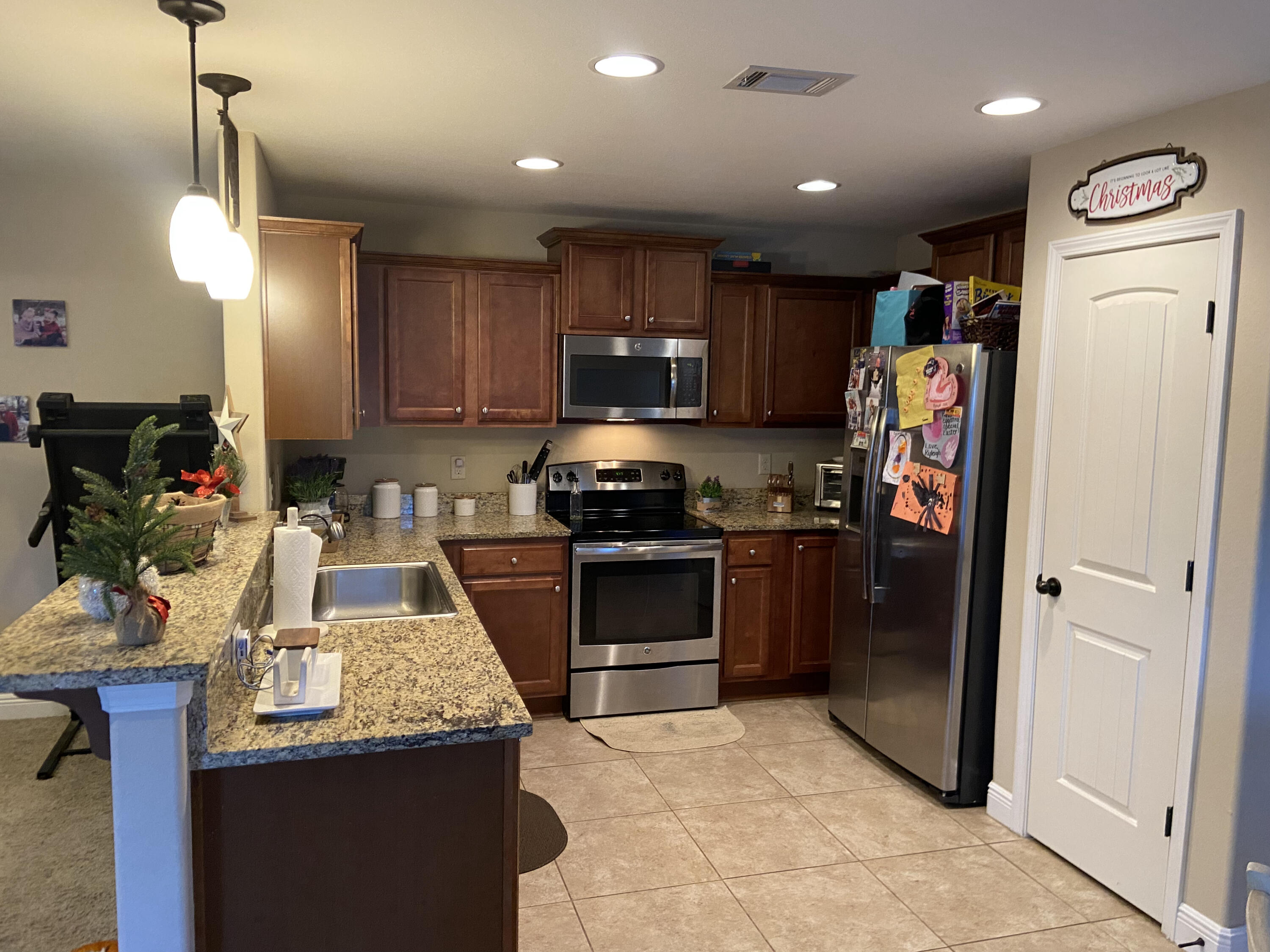 516 Grand Ridge Drive Crestview, FL 32539 - Photo 7 of 30 a kitchen with refrigerator and cabinets