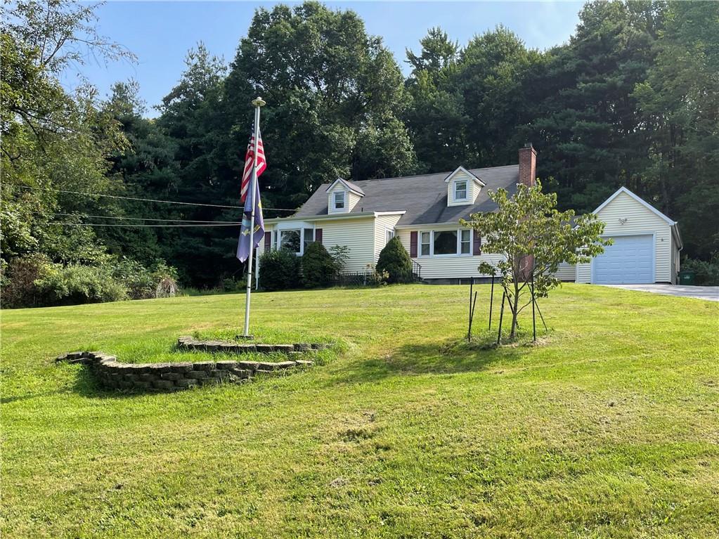 a view of an house with swimming pool and a yard