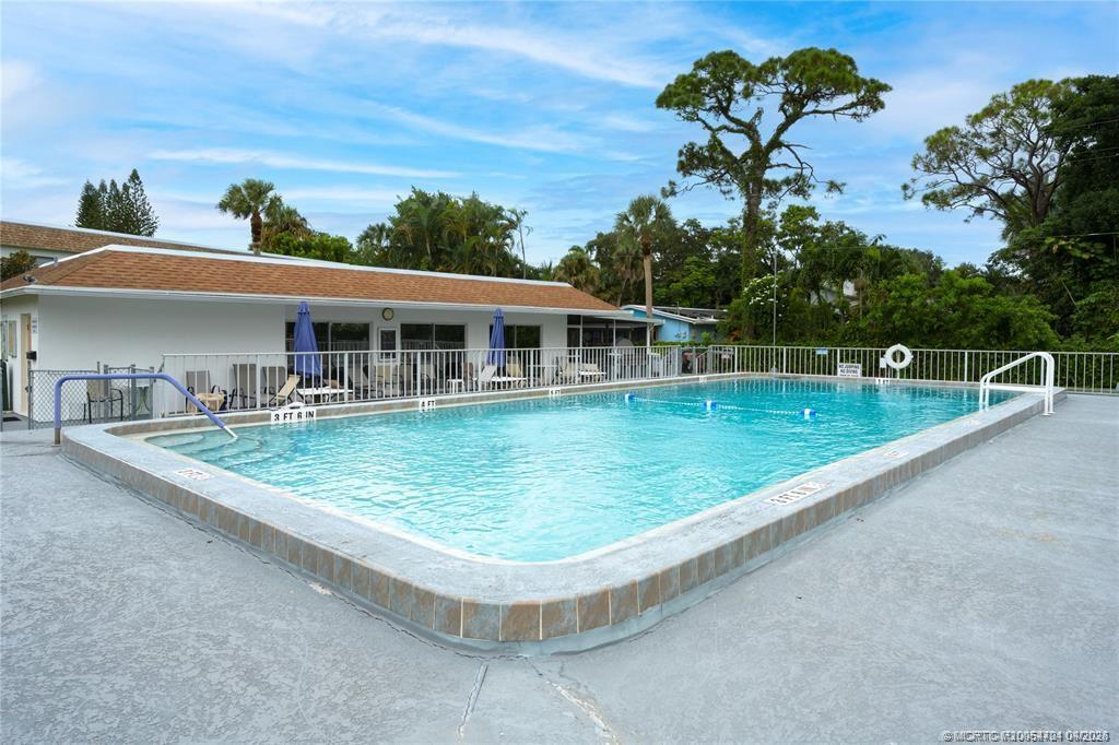 2950 Southeast Ocean Boulevard, Unit 311 Stuart, FL 34996 - Photo 1 of 16 a view of a house with a swimming pool