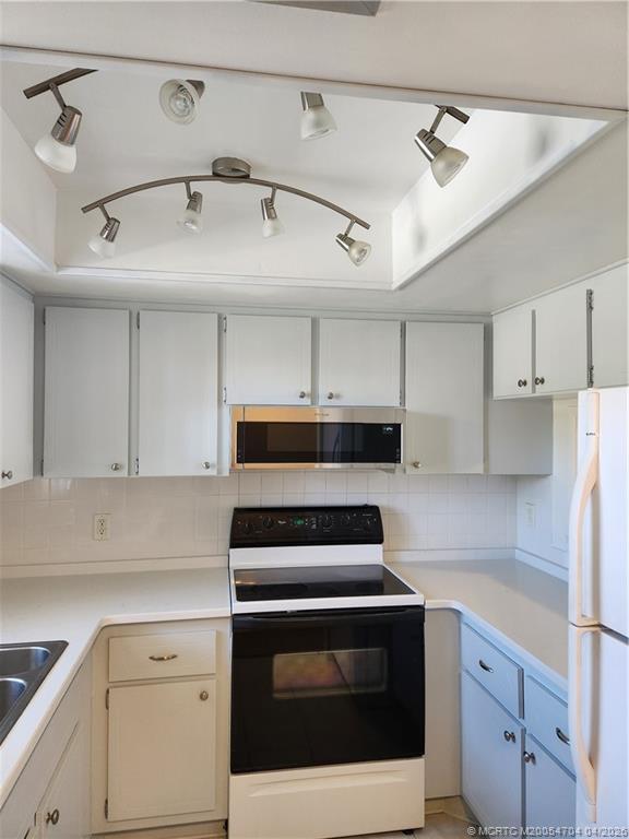 2950 Southeast Ocean Boulevard, Unit 311 Stuart, FL 34996 - Photo 11 of 16 a kitchen with cabinets and appliances