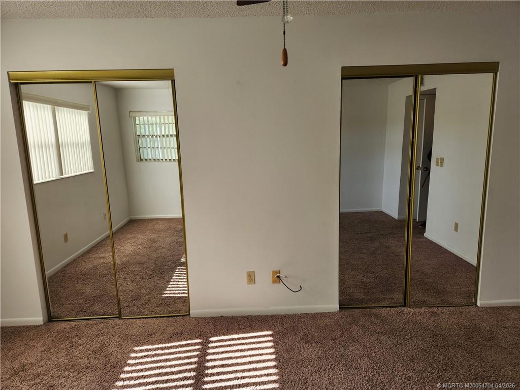 2950 Southeast Ocean Boulevard, Unit 311 Stuart, FL 34996 - Photo 13 of 16 an empty room with wooden floor and windows
