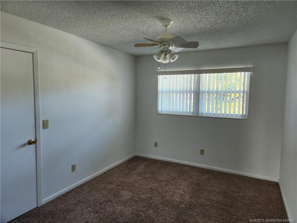2950 Southeast Ocean Boulevard, Unit 311 Stuart, FL 34996 - Photo 15 of 16 an empty room with windows and fan
