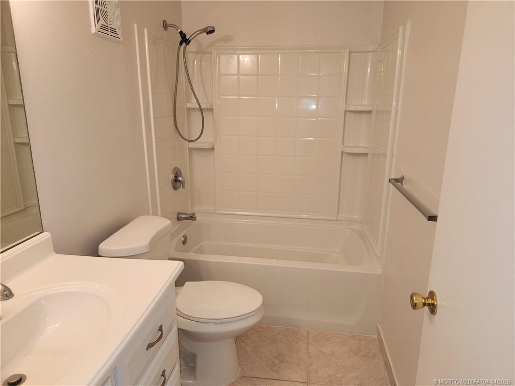 2950 Southeast Ocean Boulevard, Unit 311 Stuart, FL 34996 - Photo 16 of 16 a bathroom with a granite countertop toilet sink and shower