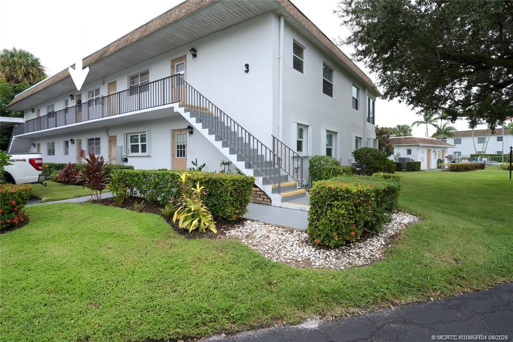 2950 Southeast Ocean Boulevard, Unit 311 Stuart, FL 34996 - Photo 4 of 16 a view of a house with a yard and potted plants