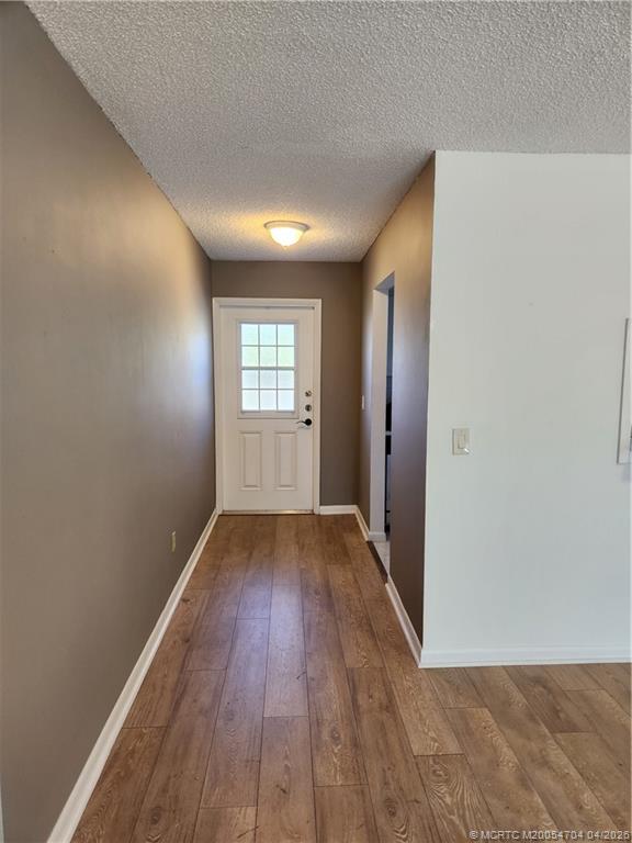2950 Southeast Ocean Boulevard, Unit 311 Stuart, FL 34996 - Photo 8 of 16 wooden floor in an empty room with a window